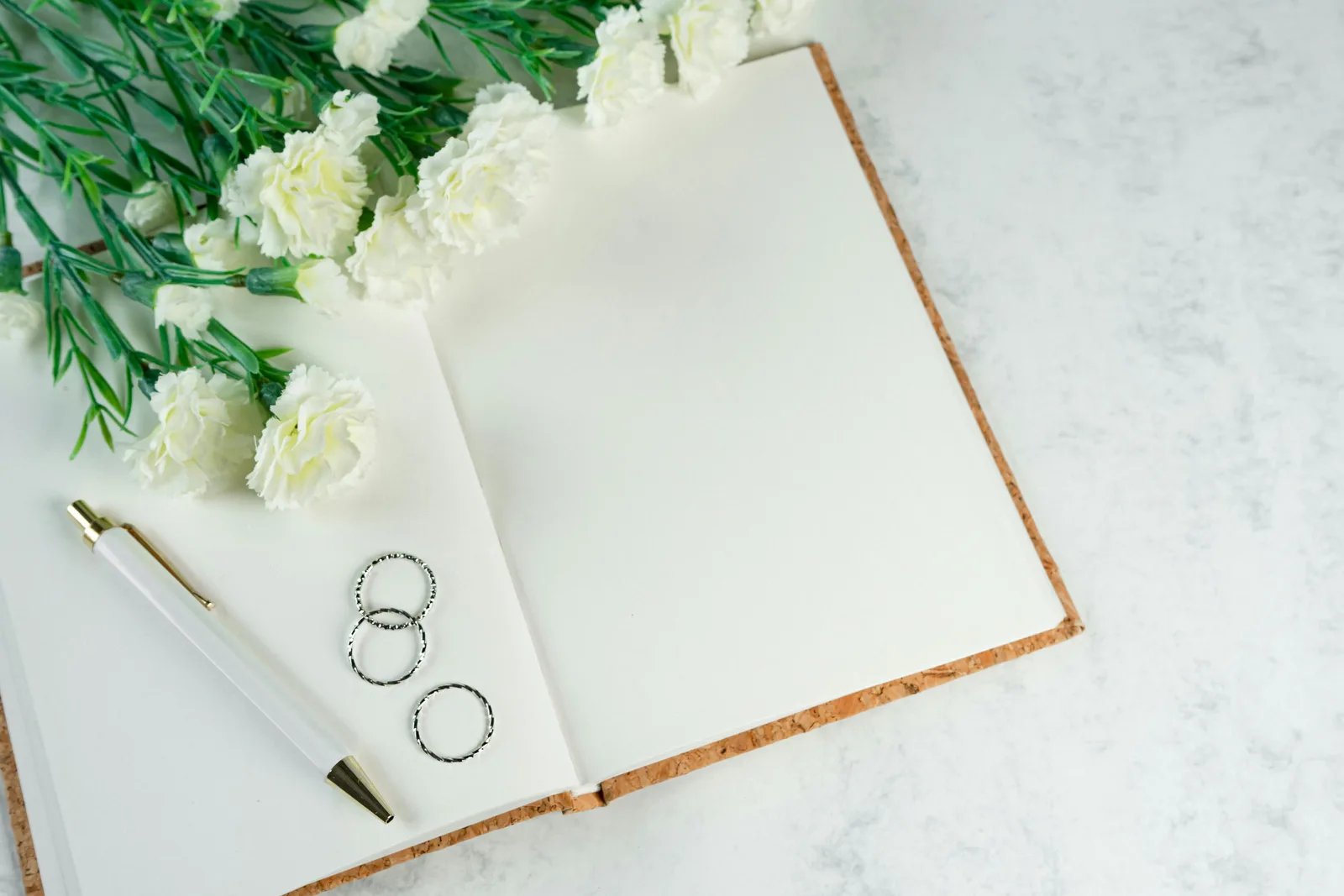 Wedding planning checklist with a white floral accent at a New Zealand or Australian wedding