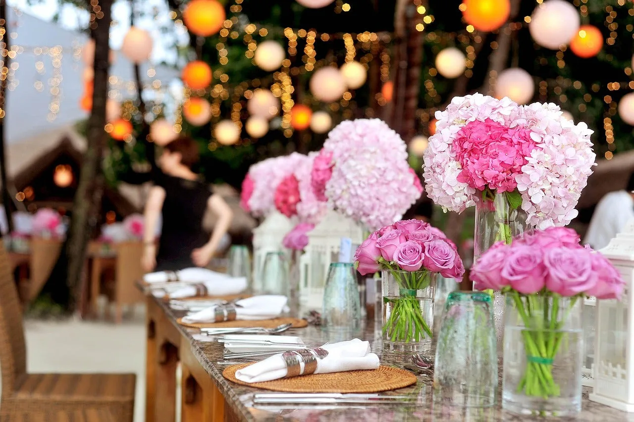 Pink rose and hydrangea floral centerpiece on a wedding reception table in Australia