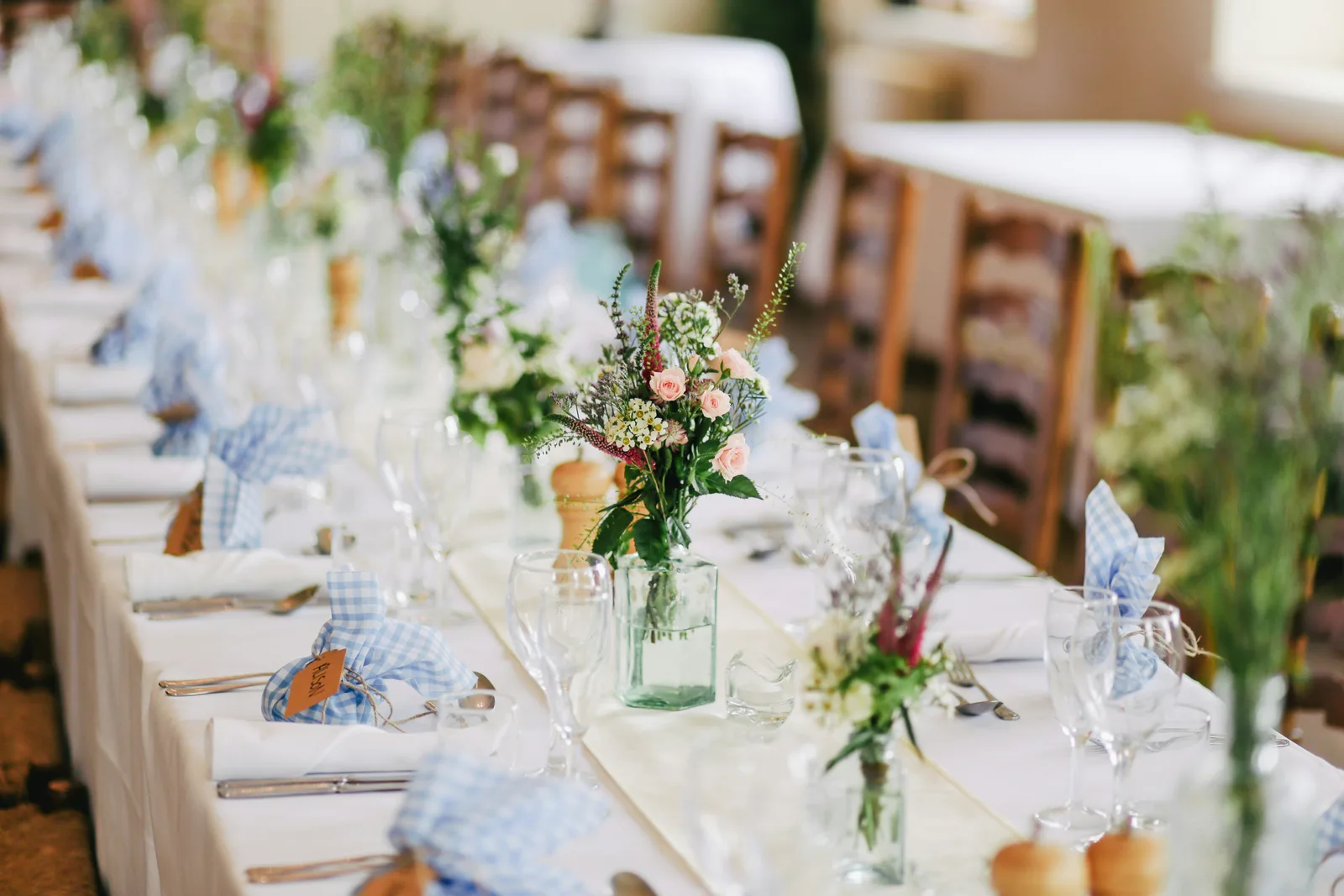 Elegant wedding reception tables and chairs with a stunning floral centerpiece in Australia